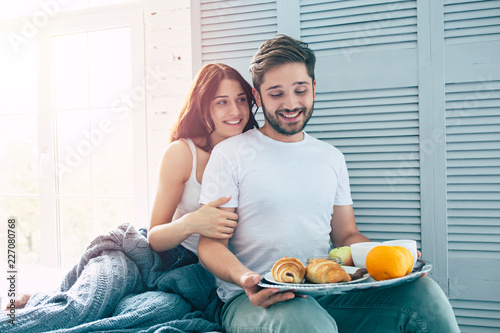 Happy Beautiful Cute Couple In Bedroom They Are Eating A