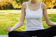 © Olesia - Girl meditates while practicing yoga outdoors in park