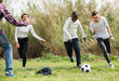 teenage friends playing football