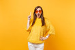 Shocked excited young woman in sweater, heart orange glasses pointing index finger up on copy space isolated on bright yellow background. People sincere emotions, lifestyle concept. Advertising area.