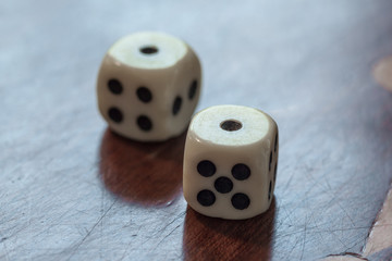 White dice on wooden background. Concept of luck, chance and leisure fun, number 1