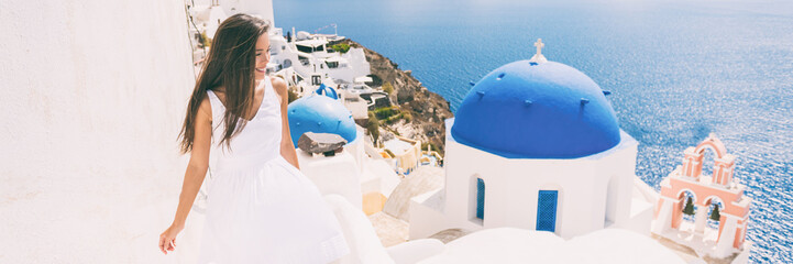 Fototapete - Santorini travel tourist woman on vacation in Oia walking on stairs visiting the famous white village with the mediterranean sea and blue domes. Europe summer destination panoramic banner.