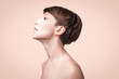 © Solarisys - Beautiful woman. Female face close up. Portrait of young caucasian woman at studio isolated on pastel. Fresh skin and beauty concept. Short haircut, long neck, perfect skin. Profile