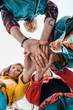 © LIGHTFIELD STUDIOS - bottom view of team of students holding hands together