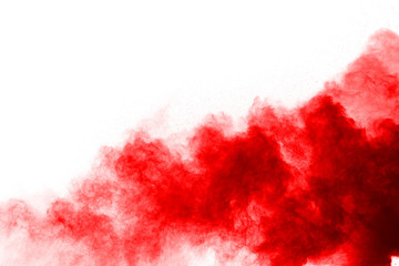 Wall Mural - freeze motion of red powder exploding, isolated on white background. abstract design of red dust clo