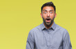 © Krakenimages.com - Adult hispanic man over isolated background afraid and shocked with surprise expression, fear and excited face.