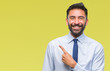 © Krakenimages.com - Adult hispanic business man over isolated background cheerful with a smile of face pointing with hand and finger up to the side with happy and natural expression on face looking at the camera.