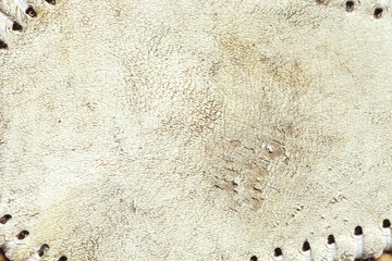 Grungy leather texture of a used baseball