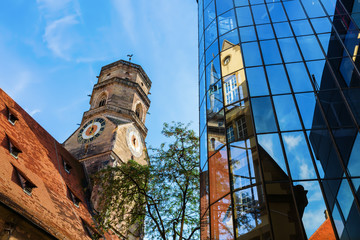 Stiftskirche with reflections in a glass facade in Stuttgart, Germany