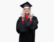© Krakenimages.com - Young blonde woman wearing graduate uniform over isolated background smiling crossing fingers with hope and eyes closed. Luck and superstitious concept.
