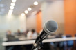 © nattanan - Microphone over the blurred business forum Meeting or Conference Training Learning Coaching Room Concept, Blurred background.