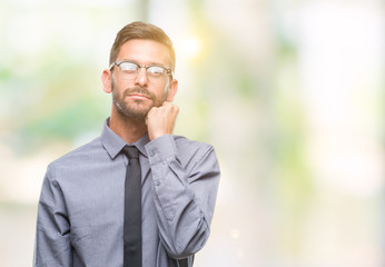 Sticker - Young handsome business man over isolated background with hand on chin thinking about question, pensive expression. Smiling with thoughtful face. Doubt concept.