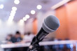 © nattanan - Microphone over the blurred business forum Meeting or Conference Training Learning Coaching Room Concept, Blurred background.