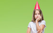 © Krakenimages.com - Young beautiful girl wearing birthday cap over isolated background thinking looking tired and bored with depression problems with crossed arms.