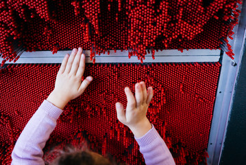 Child Playing with Science Exhibit