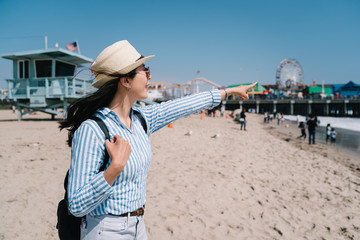 Canvas Print - a pretty female tourist standing on the beach