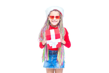 Girl in Santa's hat. Portrait of little cute girl holding box of Christmas present, Small girl hug her gift with happy and fun expression isolated on white background. Holiday gift