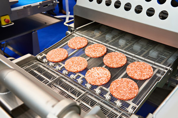 Wall Mural - Pieces of minced meat in machine wet breading