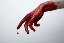 Bloody Hand Against A Light Background. Halloween Horror Concept