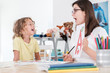 © Photographee.eu - A happy child pronouncing a letter during speech therapy with a specialist.