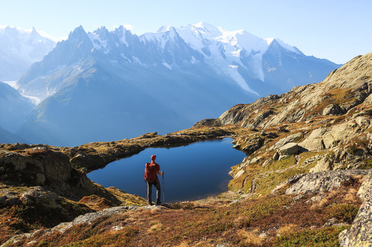 Fototapete -  - Hiker looking at Lac des Cheserys on the famour Tour du Mont Blanc near Chamonix, France.