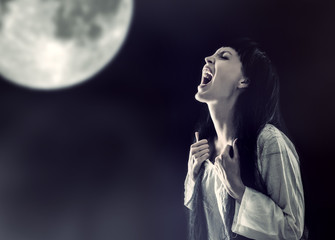 halloween zombie woman screaming on full moon