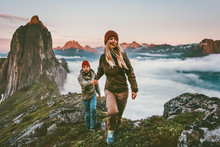Couple Travelers Holding Hands Hiking Together In Norway Travel Healthy Lifestyle Concept Active Vacations Outdoor Segla Mountain Sunset Landscape
