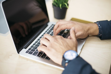 Businessman using laptop computer in office