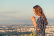© PhotoGranary - Christian worship and praise. A young woman is praying in the evening.