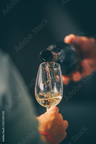 Cuadros en Lienzo White wine glass - Front view in wine market - close up tasting