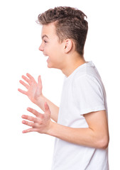 Wall Mural - Close up profile emotional portrait of caucasian teen boy wearing white t-shirt. Funny surprised teenager isolated on white background. Handsome child looking away.