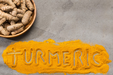 Sticker - Turmeric powder and fresh turmeric on wooden background