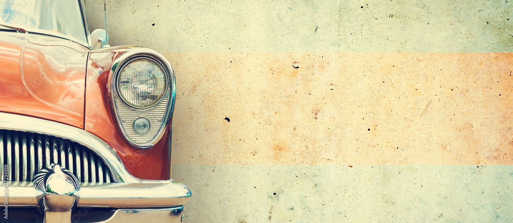 The headlight of the old beautiful car on the background of a concrete wall. Copy space. Concept banners repair, sale of cars. - obrazy, fototapety, plakaty 