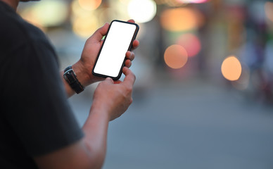 Man using mobile phone at street night.