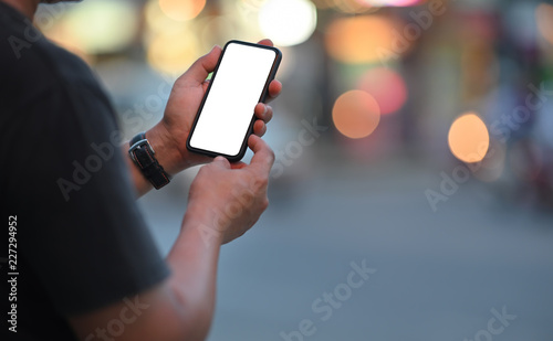 Cuadros en Lienzo Man using mobile phone at street night.