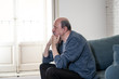 © SB Arts Media - Sad unhappy old senior man suffering from memory loss and alzheimer feeling depressed and lonely