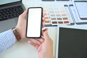 UX UI designer holding blank screen mobile phone