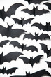 Halloween paper bat decorations on a white background.