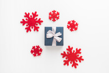 Christmas And New Year Composition. Red Snowflakes And Gift Box On White Background, Flat Lay, Top View, Copy Space