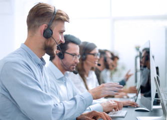 Wall Mural - handsome man with a headset working in a call center