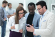 © ASDF - close up.a group of employees reading a message on a smartphone