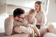 © ivanko80 - Smiling family eating popcorn at home