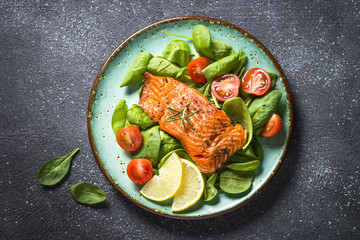 Wall Mural - Baked salmon fish fillet with fresh salad top view.