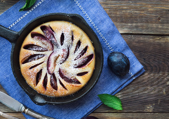 Wall Mural - Fresh homemade plum cake in iron skillet