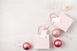Flat lay of morden minimalist Christmas gifts and wooden christmas decoration in pink pastel colors