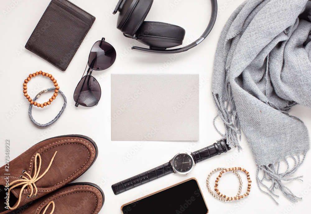 Flat lay of men's accessories with shoes, watch, phone, earphones, sunglasses, scarf over the orange background - obrazy, fototapety, plakaty 