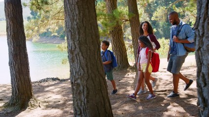 Wall Mural - Family On Hike Walking Along Path Through Woods Next To Lake