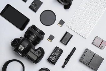 Wall Mural - flat lay composition with equipment for professional photographer on white background