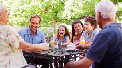 Wall Mural - Two kids at an outdoor cafe with parents and grandparents