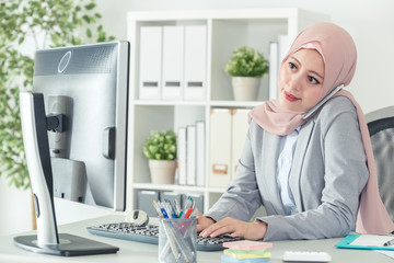 Wall Mural - indonesian businesswoman answering phone call